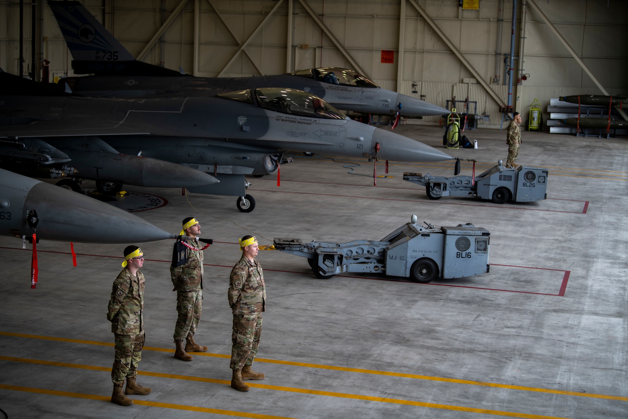 Dedicated crew chiefs and assistant DCCs assigned to the 8th Maintenance Squadron stand in front of F-16 Fighting Falcons during the Third Quarter Load Crew Competition at Kunsan Air Base, Republic of Korea, Oct. 16, 2021. The DCCs were tested on their knowledge of their aircraft, skillset and professionalism. (U.S. Air Force photo by Senior Airman Suzie Plotnikov)