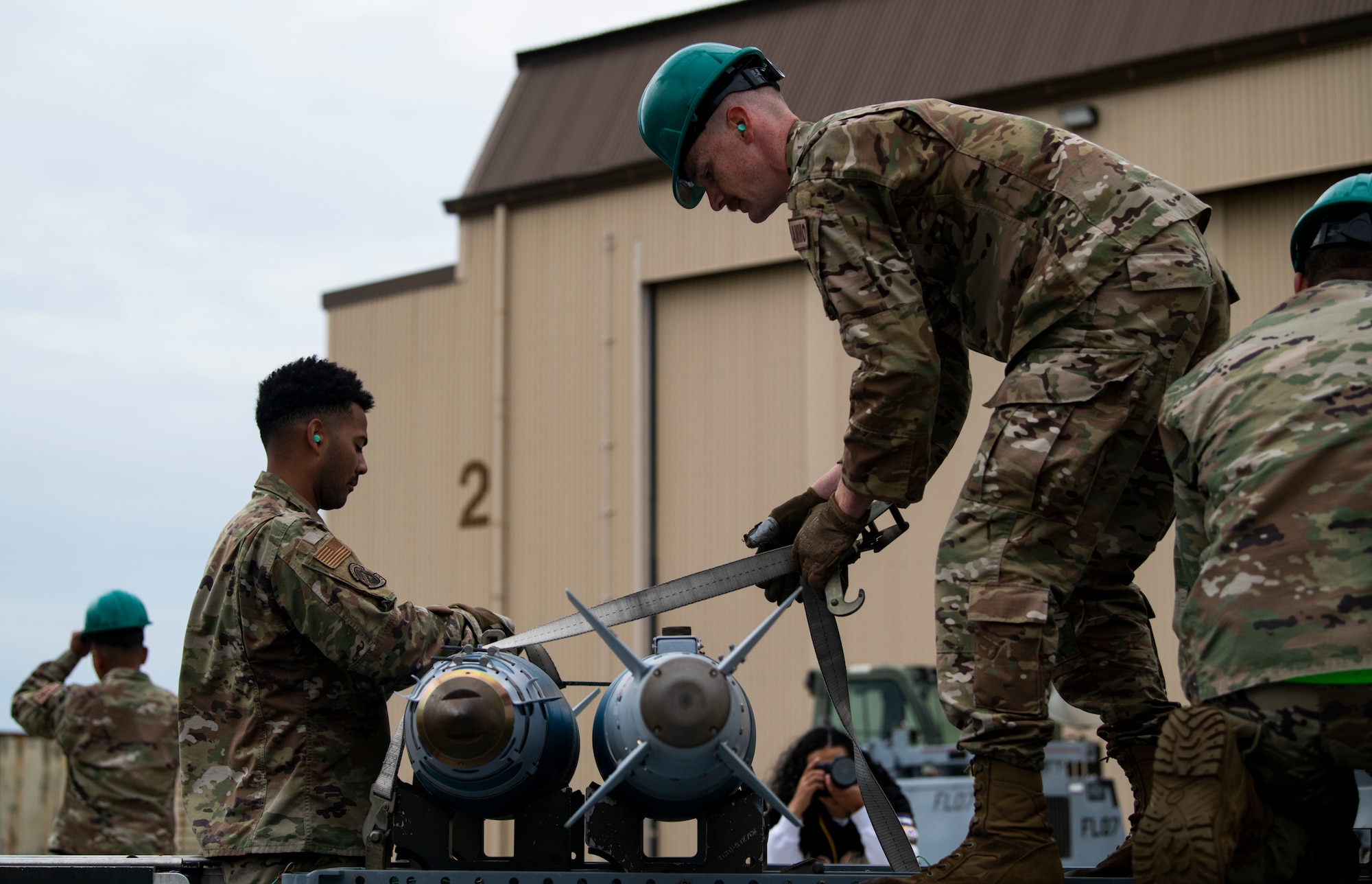 Munitions technicians from the 8th Maintenance Squadron secure munitions during the Third Quarter Load Crew Competition at Kunsan Air Base, Republic of Korea, Oct. 16, 2021. Munitions technicians had the opportunity to compete against each other in a bomb building competition. (U.S. Air Force photo by Senior Airman Suzie Plotnikov)