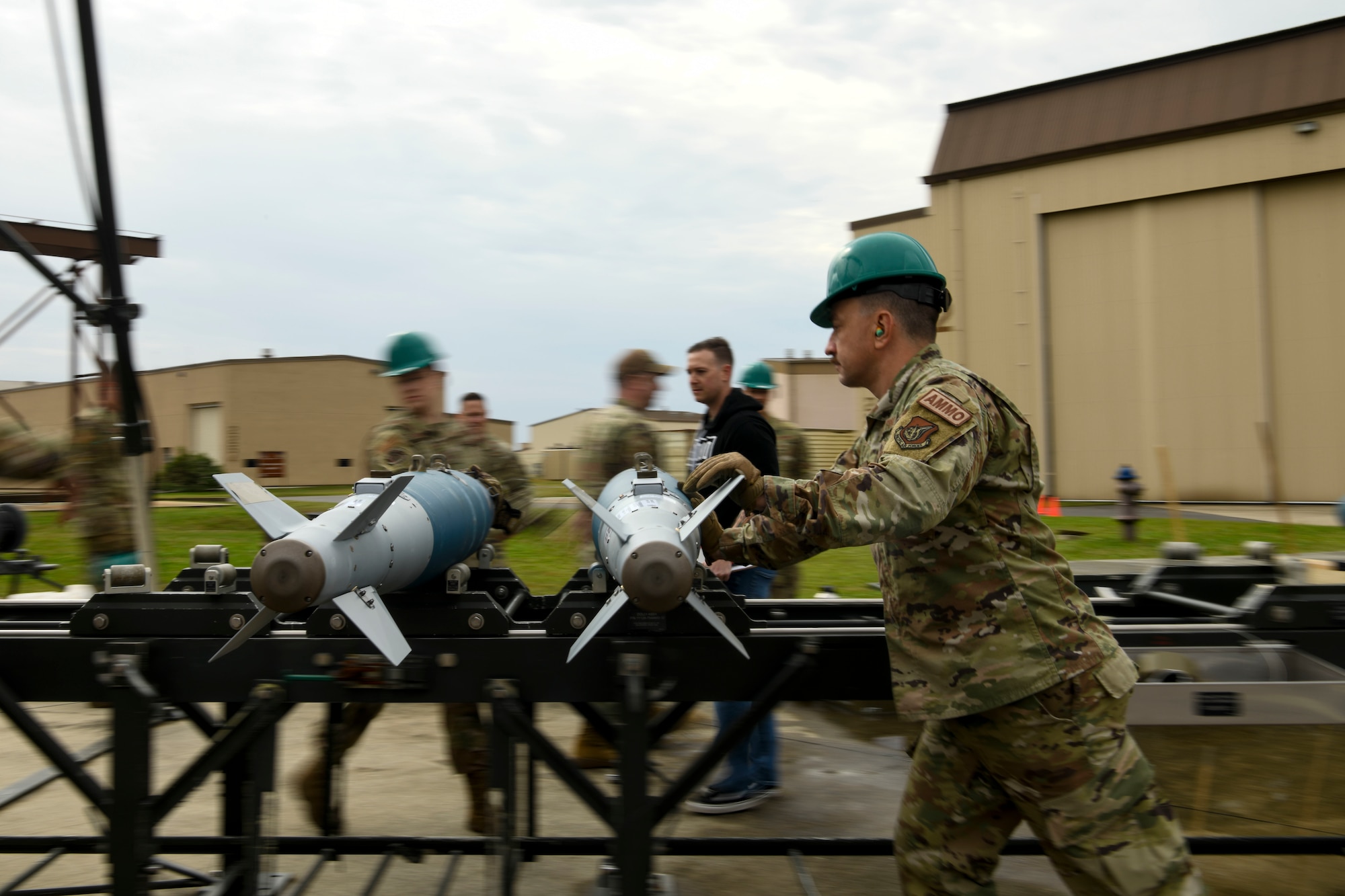 Tech Sgt. Robert Wiley, 8th Maintenance Squadron munitions technician, pushes GBU-38 bombs during the Third Quarter Load Crew Competition at Kunsan Air Base, Republic of Korea, Oct. 16, 2021. This quarter, munitions technicians had the opportunity to compete against each other in a bomb building competition. (U.S. Air Force photo by Staff Sgt. Jesenia Landaverde)