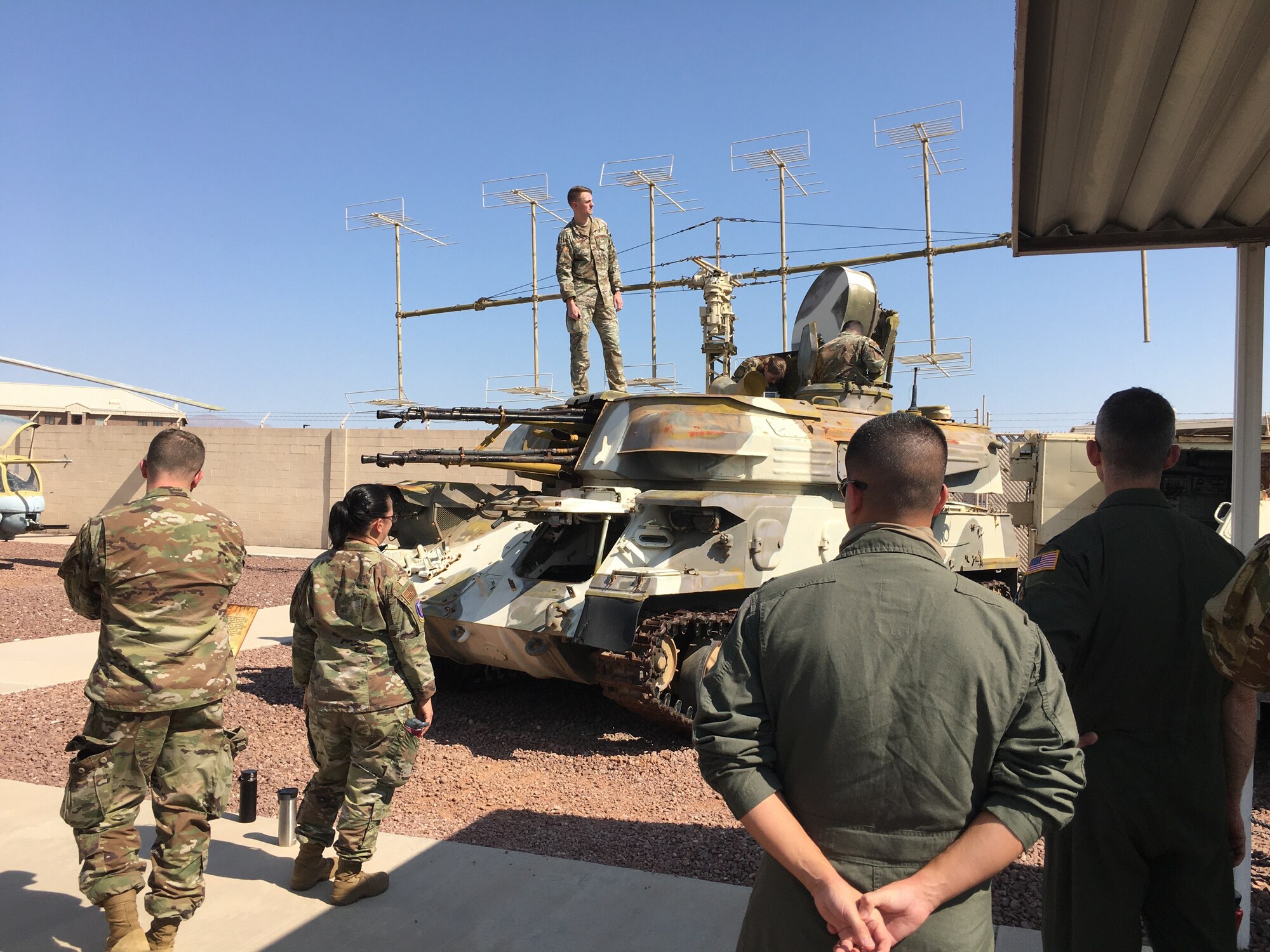 Photo of U.S. Air Force Airmen standing around a tank