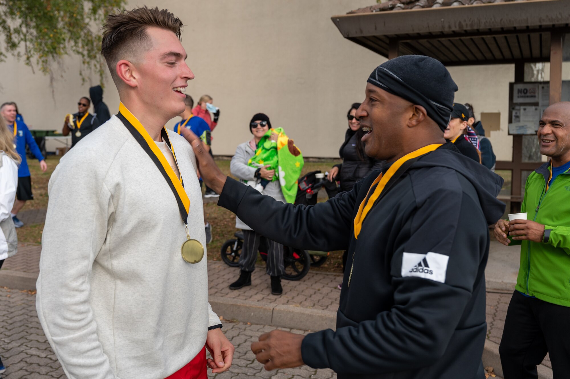 A person patting another person on the shoulder.