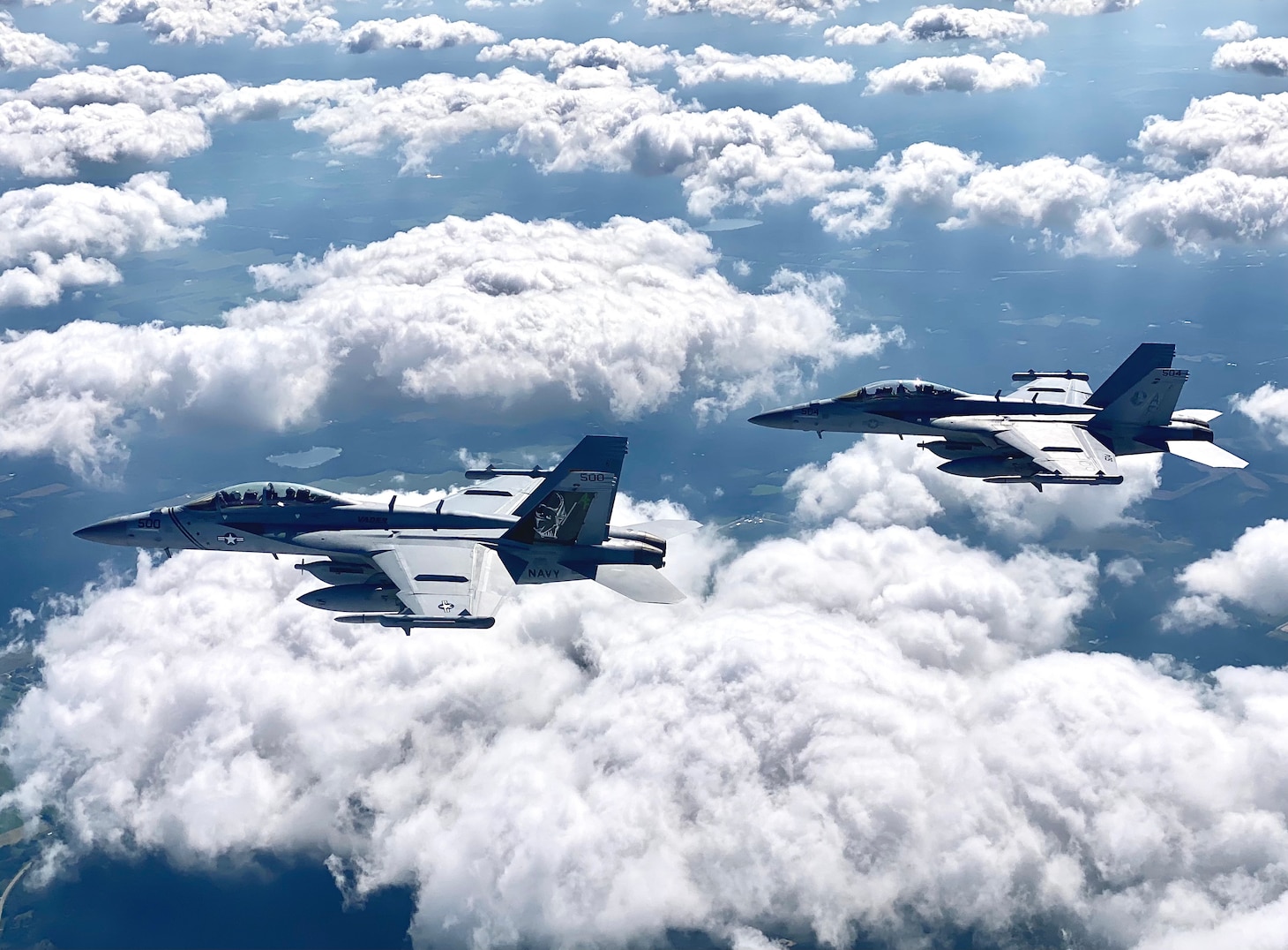 CAMP DOUGLAS, Wisc. (Aug. 17, 2021) EA-18G Growlers assigned to the "Star Warriors" of Electronic Attack Squadron (VAQ) 209 fly over Camp Douglas, Wisc. during Northern Lightning 2021. Northern Lightning is a full-spectrum Counterland training exercise hosted at Volk Field Air National Guard Base. The goal of the exercise is to provide a tailored, cost effective and realistic combat training for the Department of Defense Total Force. (U.S. Navy photo by Cmdr. Pete Scheu)