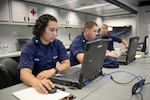 Petty Officer 2nd Class Kelly Badal, a crew member of Coast Guard Communication Command, works on a computer inside a Coast Guard enhanced mobile incident command post (EMICP) in Bayonne, N.J., Wednesday, Sept. 23, 2015. The EMICP provided a spacious and climate-controlled environment, voice and data connectivity as well as acted as the security command post during the papal visit and United Nations General Assembly in New York. (Coast Guard photo by Petty Officer 3rd Class Frank Iannazzo-Simmons)