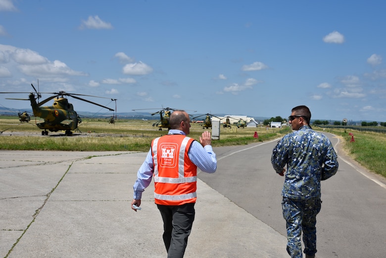 U.S. Army Corps of Engineers, Europe District Southern Europe Area Engineer Bryce Jones discusses plans for future construction projects at Campia Turzii Air Base, Romania with Romania Air Force Chief of the Host Nation Support Office Maj. Cosmin Tanase during a site visit June 21, 2021. Jones was recognized as the U.S. Army Corps of Engineers Administrative Contracting Officer of the Year during a virtual ceremony October 25, 2021 for his work in support of the U.S. Army Corps of Engineers missions in Romania as well as several other Southern European countries. (U.S. Army photo by Chris Gardner)