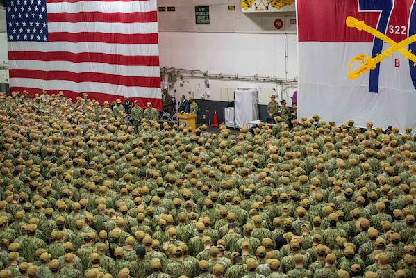 Secretary of the Navy Carlos Del Toro speaks to the crew during an all hands call in the hangar bay of the U.S. Navy's only forward-deployed aircraft carrier USS Ronald Reagan (CVN 76).