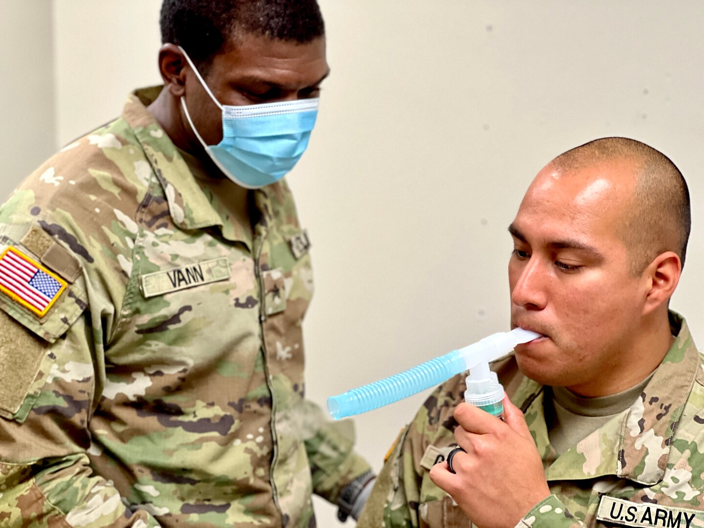Sgt. Elvin E. Vann III and Cpl. Giovani Gonzalez, respiratory specialists at Bayne-Jones Army Community Hospital, demonstrate a nebulizer treatment.