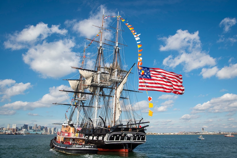 An old fashioned sailing ship moves across the water.