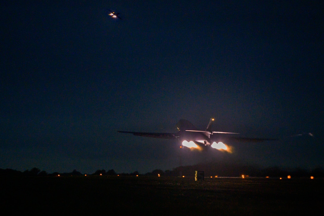 An aircraft takes off from an airport in the dark.