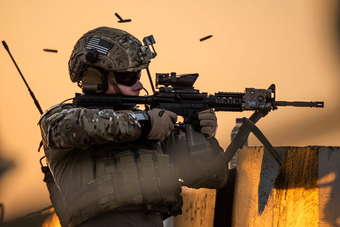 As an airman fires a weapon, the ammunition flies around him.