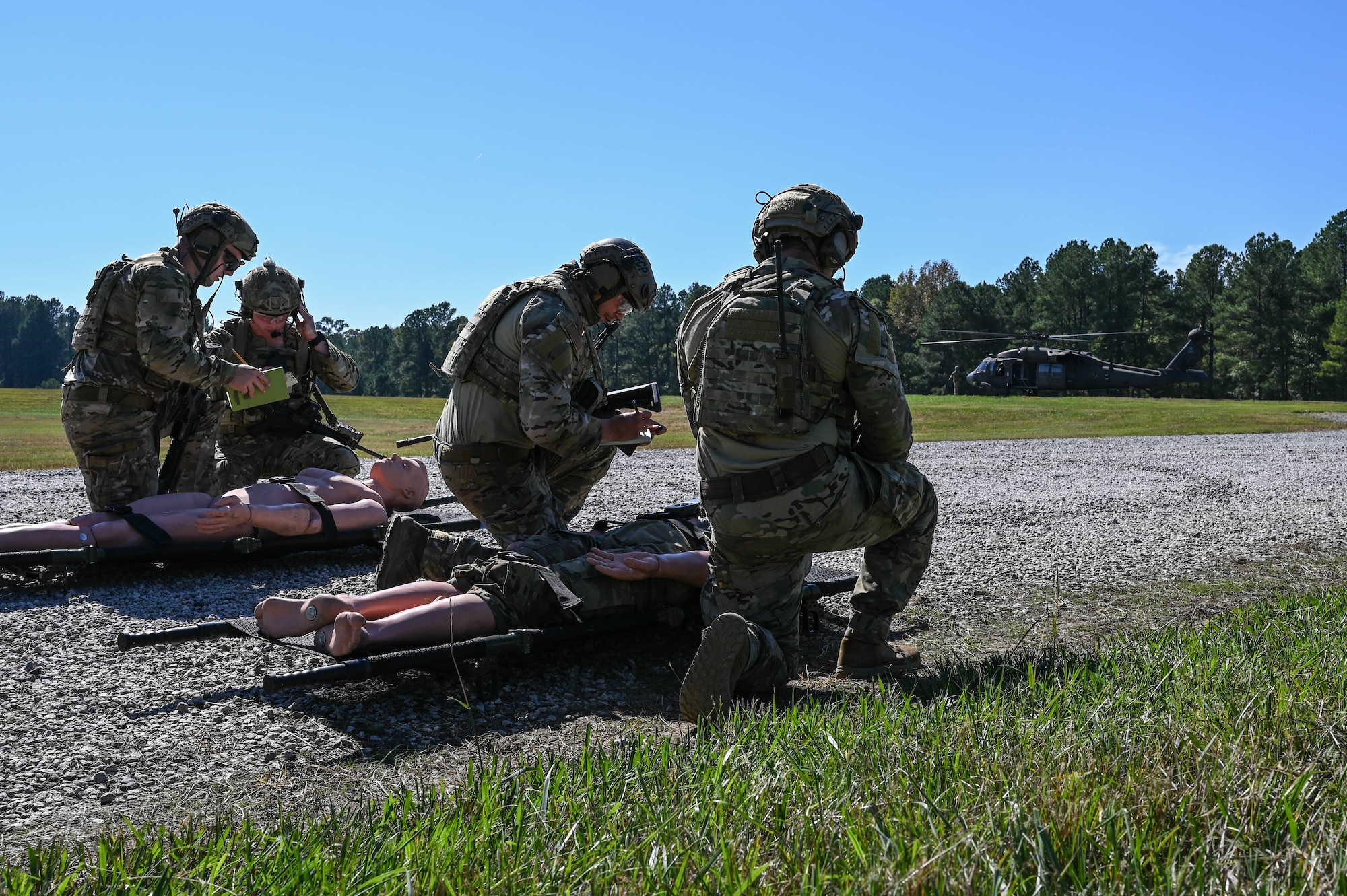 people kneeling over a gurney