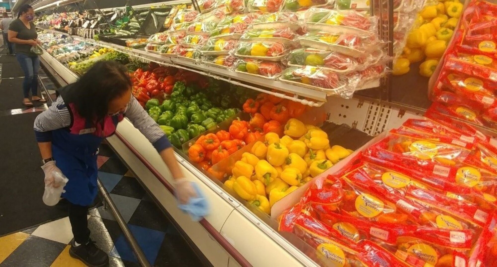 person wiping down counter