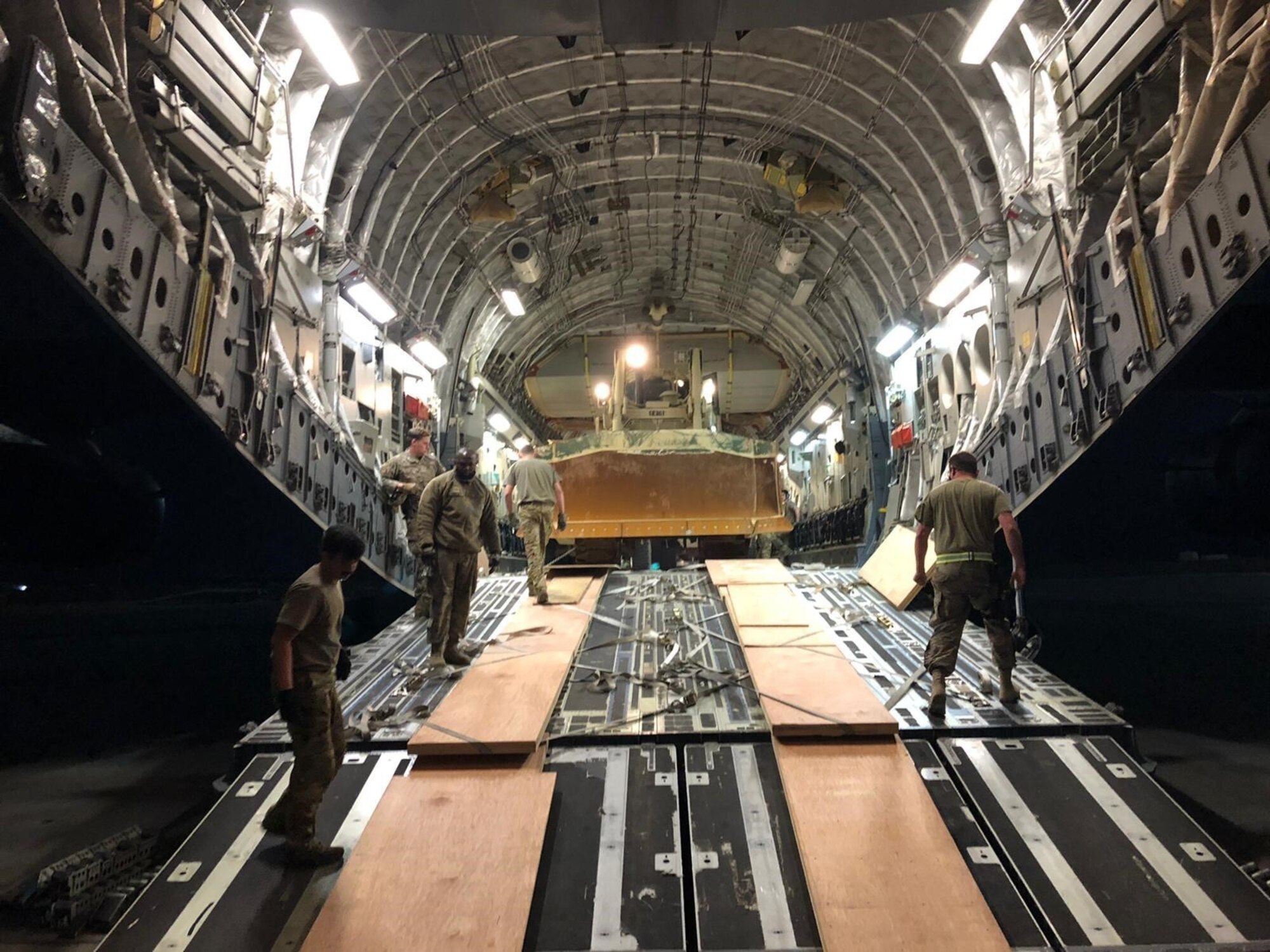 U.S. Air Force Airmen offload a bulldozer from a C-17 Globemaster III at al-Asad Air Base, Iraq.