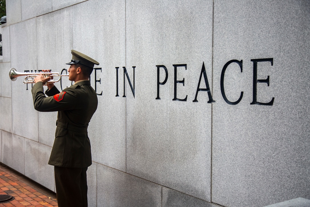 U.S. Marine Corps Cpl. Wilber A. Hernandez, a musician, headquarters battalion, 2nd Marine Division, plays the bugle at the 38th Beirut Memorial Observance Ceremony at the Lejeune Memorial Gardens in Jacksonville, North Carolina, Oct. 23, 2021.