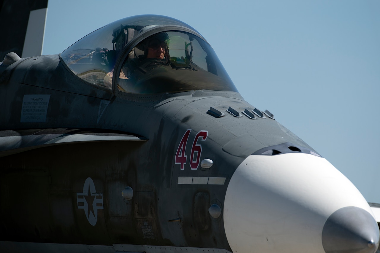 A pilot taxis an aircraft at a medium close range.