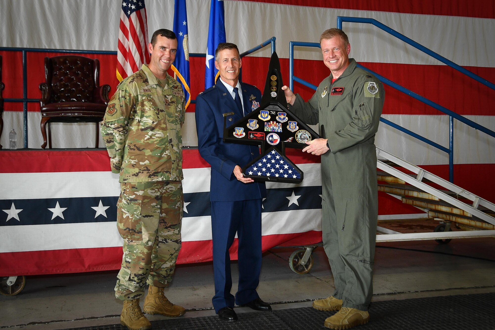 (right) 301st Fighter Wing Commander Col. Allen "Jax" Duckworth and (left) 301 FW Command Chief Master Sgt. Michael Senigo present Col. Kevin "Fuzzy" Zeller with a token of appreciation during his retirement ceremony at Naval Air Station Joint Reserve Base Fort Worth, Texas, Oct. 23, 2021. Zeller earned his commission through the Officer Training School program after graduating from the University of Oklahoma. (U.S. Air Force photo by Jeremy Roman)