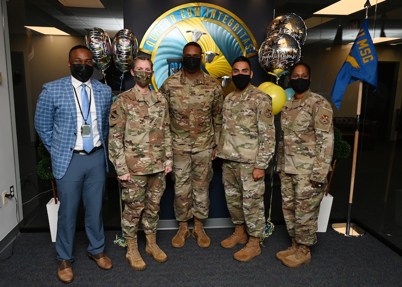 U.S. Air Force Master Sgt. Kade Forrester (Center), 11th Contracting Squadron Infrastructure Flight section chief at Joint Base Anacostia-Bolling, Washington, D.C., stands for a photo with JBAB and his CONS leadership team during a recognition ceremony on Oct. 21, 2021. Forrester became one of the first two enlisted Airmen to ever be selected to attend Naval Postgraduate School. Forrester will attend the 18-month Acquisitions and Contract Management program in Monterey, California. (U.S. Air Force photo by Staff Sgt. Kayla White)