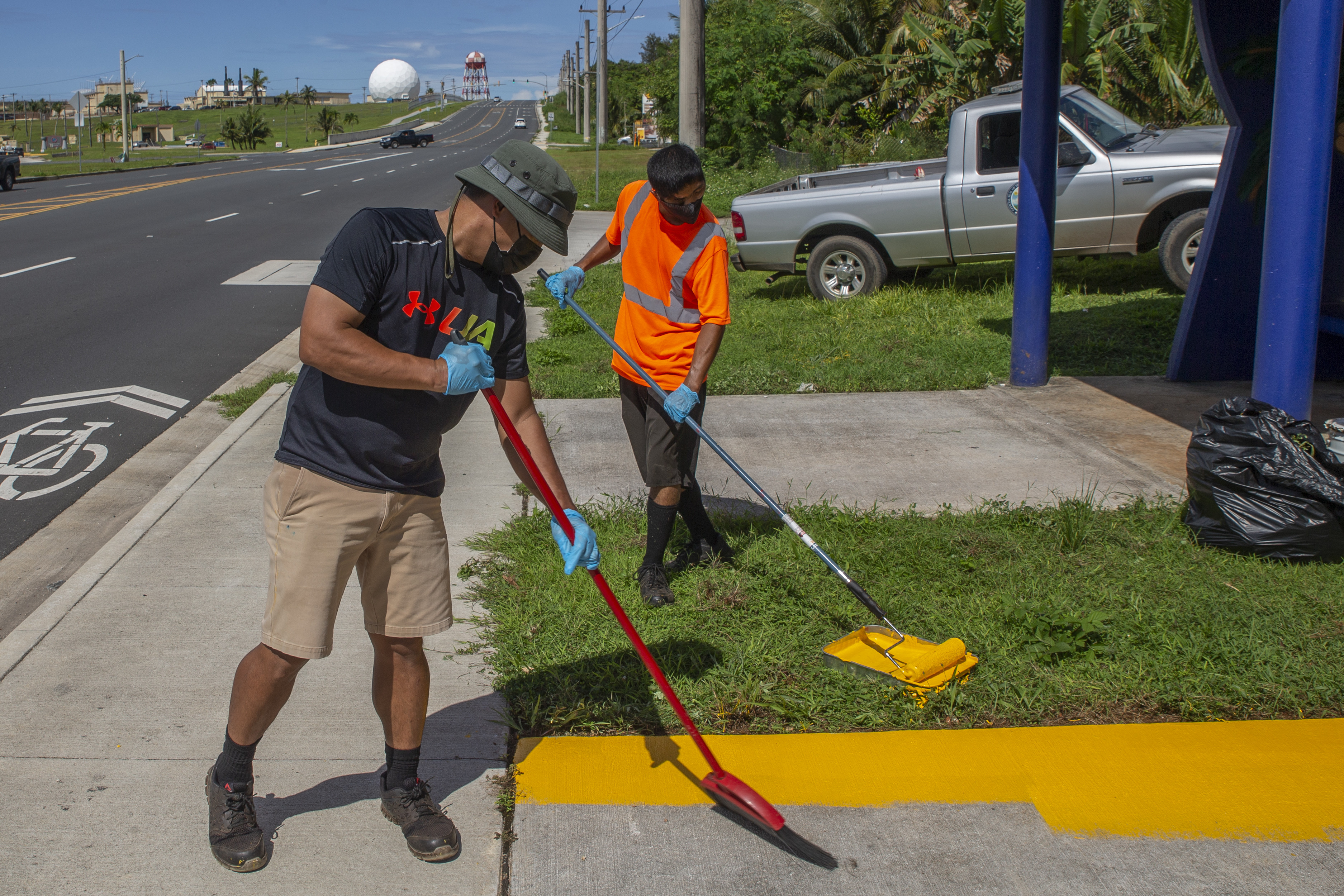 Volunteers with the Dededo Mayor’s Office paint a bus stop located across from Naval Computer and Telecommunications Station (NCTS) Guam, Oct. 20, 2021.