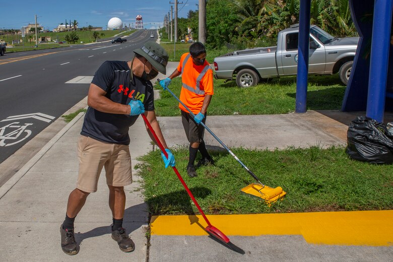 Volunteers with the Dededo Mayor’s Office paint a bus stop located across from Naval Computer and Telecommunications Station (NCTS) Guam, Oct. 20, 2021.