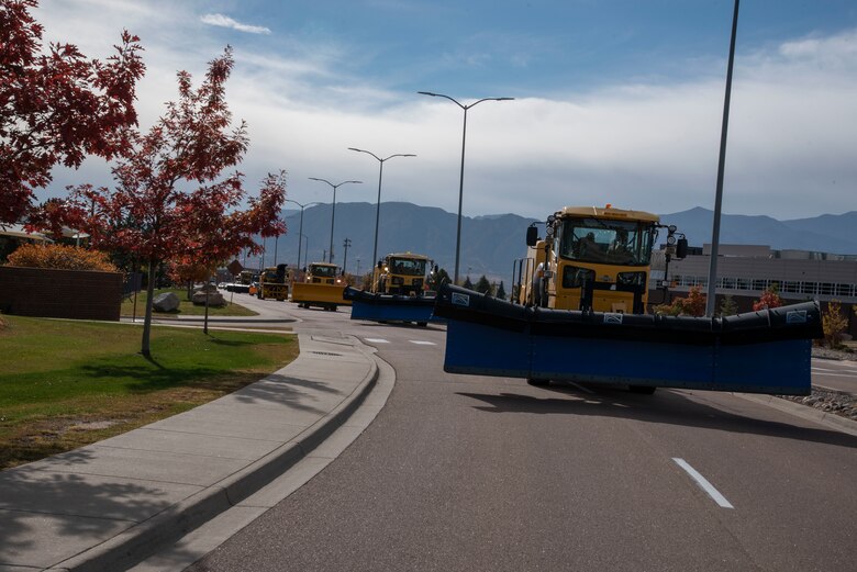 Each year, leadership from Peterson Space Force Base, Colorado, drive snow plows and snow blowers during the Snow Parade to showcase the installations snow removal capabilities.