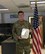 A photo of an Airman holding a medal