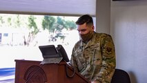 A photo of an Airmen giving an announcement.