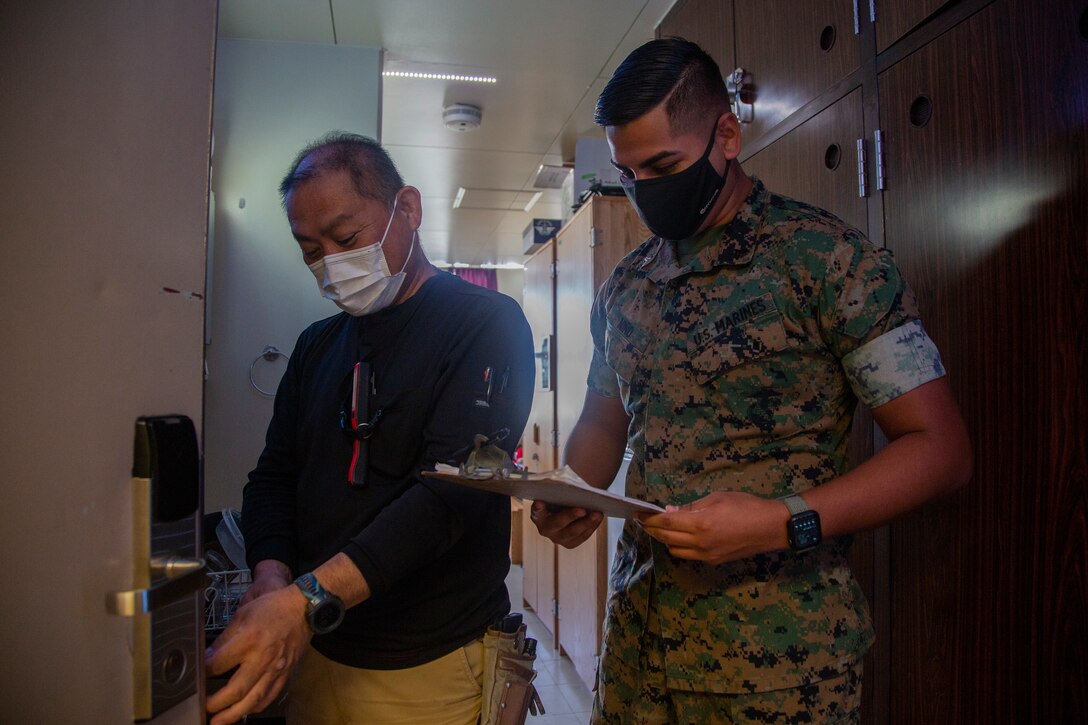 U.S. Marine Corps Cpl. Matthew Niño, a barracks manager with Headquarters and Support Battalion, Marine Corps Installations Pacific, performs maintenance checks on barracks rooms with Nakasone Moriaki, a Master Labor Contractor with General Facilities, MCIPAC, at Company B barracks on Camp Foster, Okinawa, Japan, Oct. 14, 2021. As a barracks manager, Niño is responsible for the upkeep and maintenance of his barracks, and directly supports unit morale and cohesion through the constant improvements and renovations he oversees for the barracks. Niño is a native of McAllen, Texas. (U.S. Marine Corps photo by Lance Cpl. Ricardo Deseanogomez)
