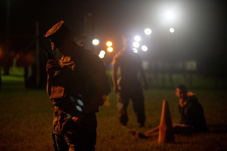 U.S. Marine Corps Cpl. James Langford, an inventory management specialist with Security Guard Force, Camp Courtney, establishes radio communication with Marine Corps Base Camp Butler Explosive Ordnance Disposal during Operation Constant Vigilance on Camp Courtney, Okinawa, Japan, Oct. 19, 2021. After a visual confirmation of a simulated vehicle-borne improvised explosive device, SGF and Explosive Ordnance Disposal, with Marine Corps Base Camp Butler, conducted response measures to include detainee handling, EOD robotics techniques, and vehicle inspection procedures. Constant Vigilance is an island-wide force protection condition evaluation and crisis response to validate regional, installation, camp, and tenant antiterrorism and mission assurance plans and policies. (U.S. Marine Corps photo by Lance Cpl. Alex Fairchild)