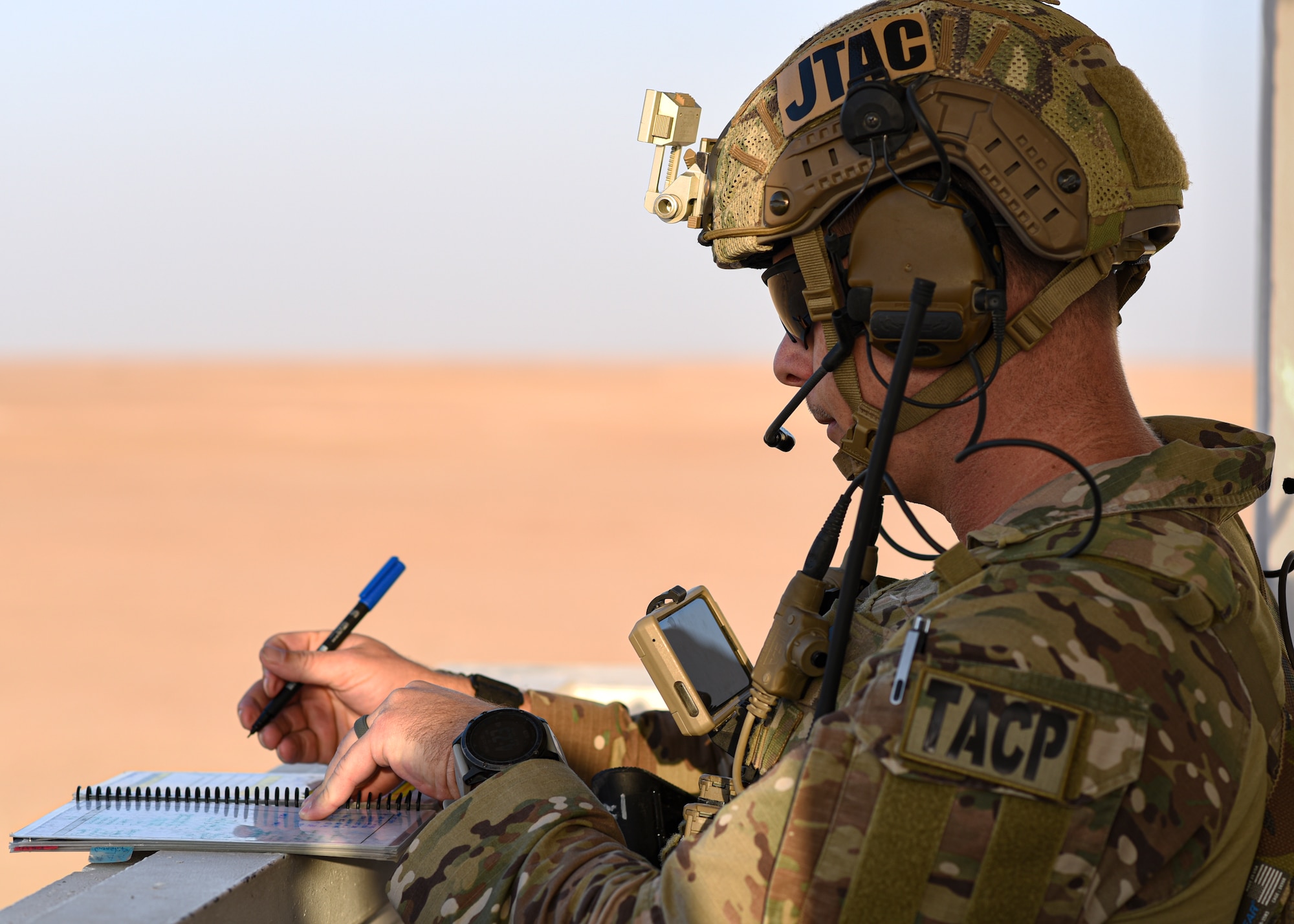 U.S. Air Force Tech. Sgt. Jason Waters, 82nd Expeditionary Air Support Operations Squadron joint terminal attack controller, reviews coordinates on a topographical map at Udairi Range, Kuwait, Oct. 21, 2021. USAF JTACs deployed to the 82nd EASOS, along with the U.S. Army 1st Battalion 194th Armor Regiment joint fires observers in-training, and the Italian air force (Aeronautica Militare) Task Group Typhoon practiced close air support, fostered enduring partnerships and advanced its decisive combat dominance during a live-fire training exercise. (U.S. Air Force photo by Staff Sgt. Ryan Brooks)