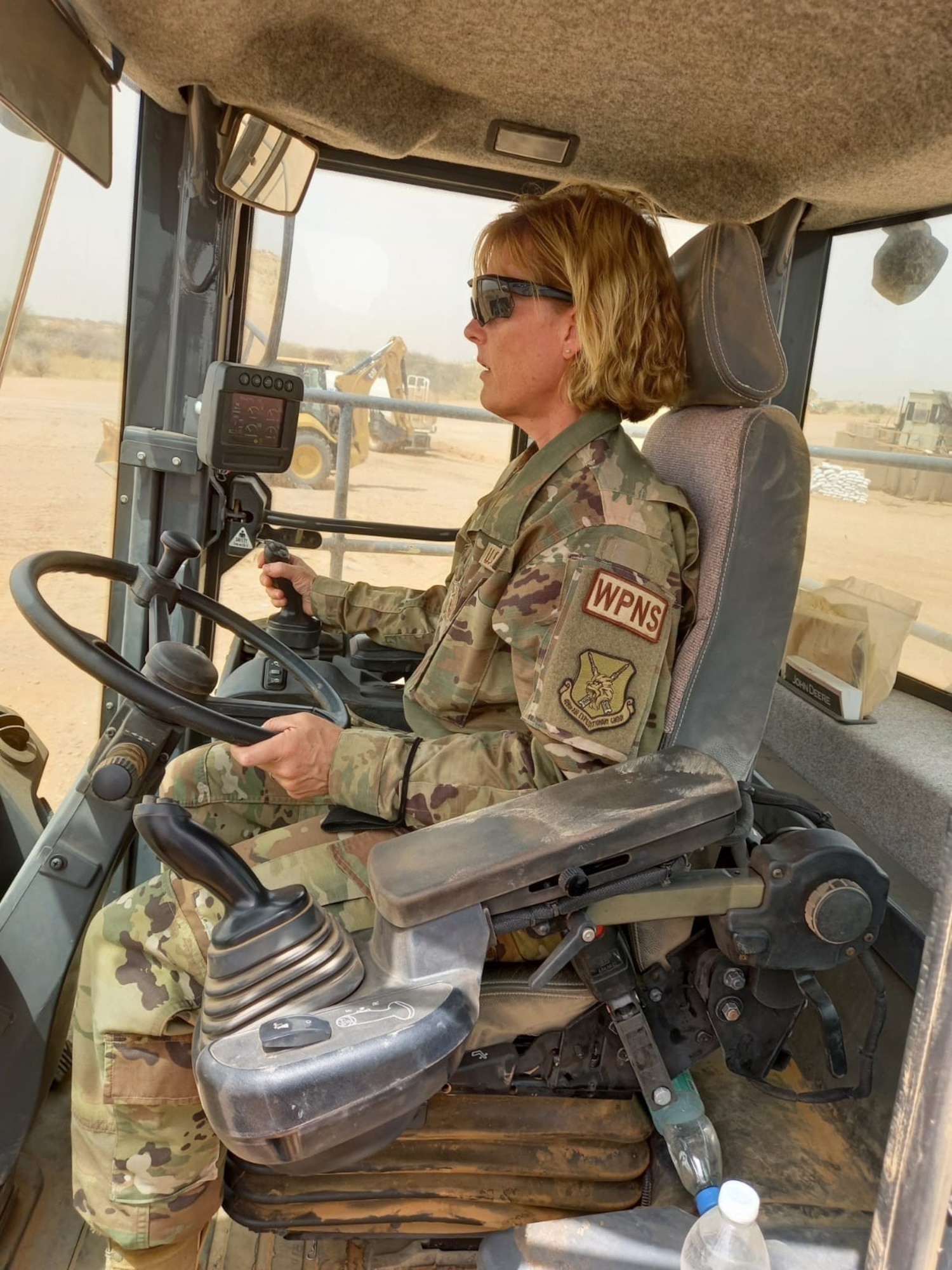 U.S. Air Force Master Sgt. Andrea Senecal, 158th Force Support Flight services superintendent, Vermont Air National Guard, operates heavy machinery while deployed to Airbase 201, Niger.