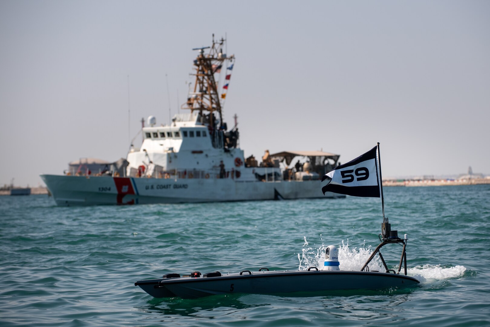A MANTAS T-12 unmanned surface vessel (USV), front, operates alongside U.S. Coast Guard patrol boat USCGC Maui (WPB 1304) during exercise New Horizon in the Arabian Gulf, Oct. 26. Exercise New Horizon was U.S. Naval Forces Central Command Task Force 59’s first at-sea evolution since its establishment Sept. 9.