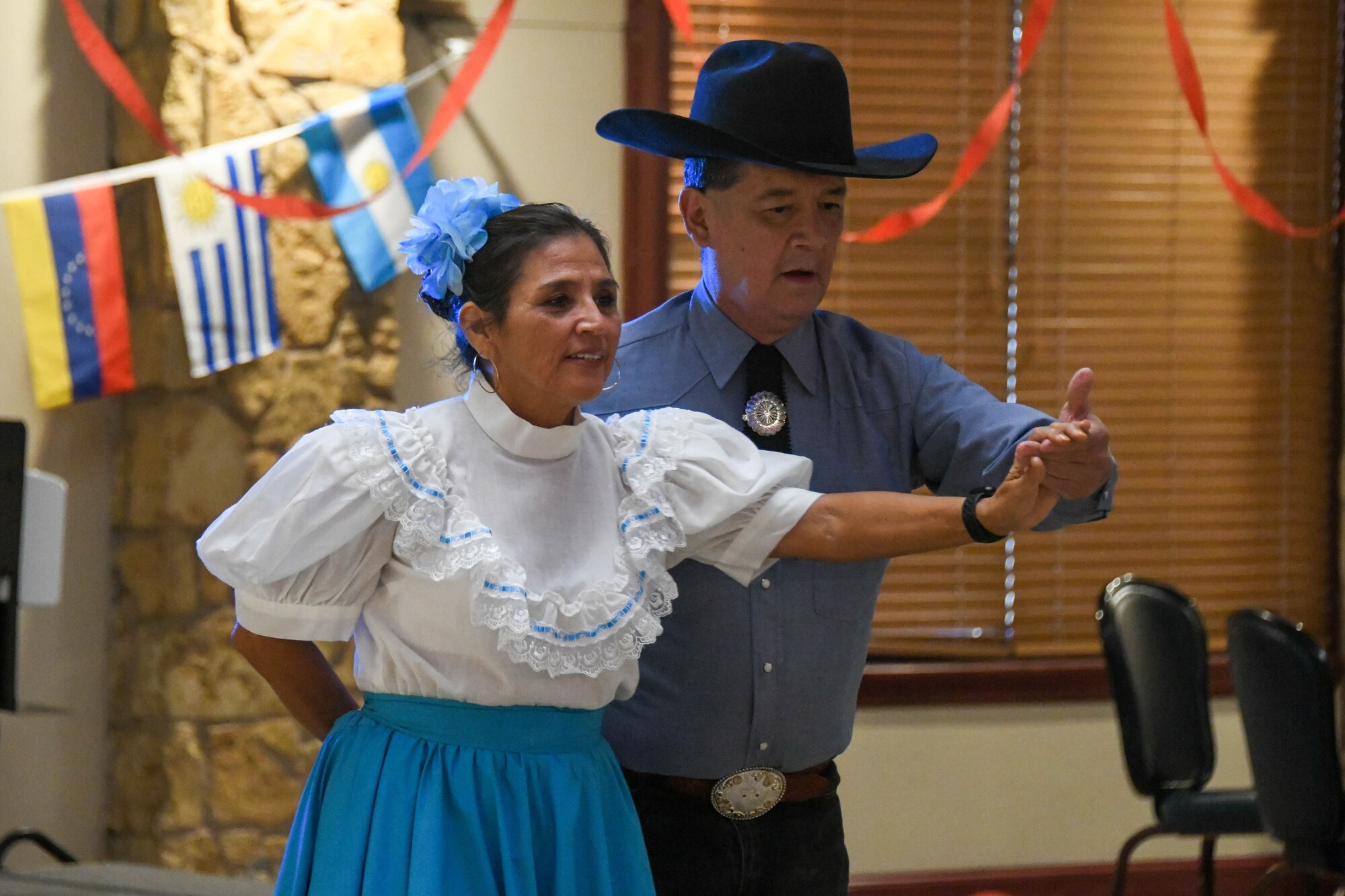 Tijerina Flora Pineda and Gerardo Chavez, Lawton Mexican Folkloric Dance performers, perform a traditional Hispanic dance for Airmen and families at a fiesta on Altus Air Force Base, Oklahoma, October 15, 2021. The performances are an opportunity to showcase different traditional Hispanic dances, as well as educate spectators about different cultures. (U.S. Air Force photo by Airman 1st Class Trenton Jancze)