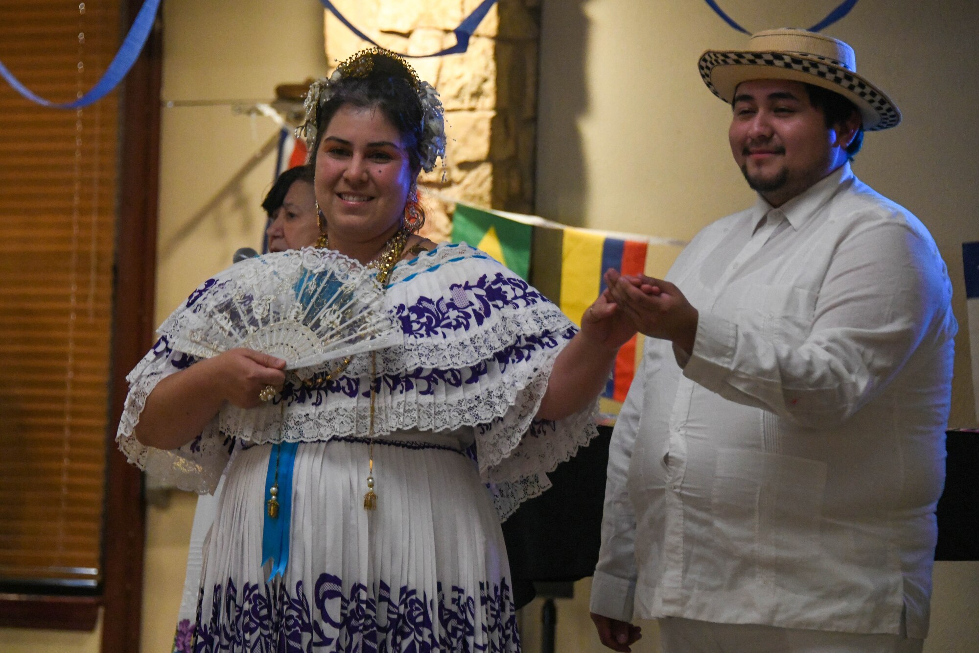 Vanessa Sargent and Alfredo Miguel Martinez, Lawton Mexican Folkloric dancers pose before a dance at a fiesta on Altus Air Force Base, Oklahoma, October 15, 2021. The fiesta was an opportunity for Airmen and family members to enjoy traditional Latin dishes, as well as learn more about Latin culture through dance. (U.S. Air Force photo by Airman 1st Class Trenton Jancze)