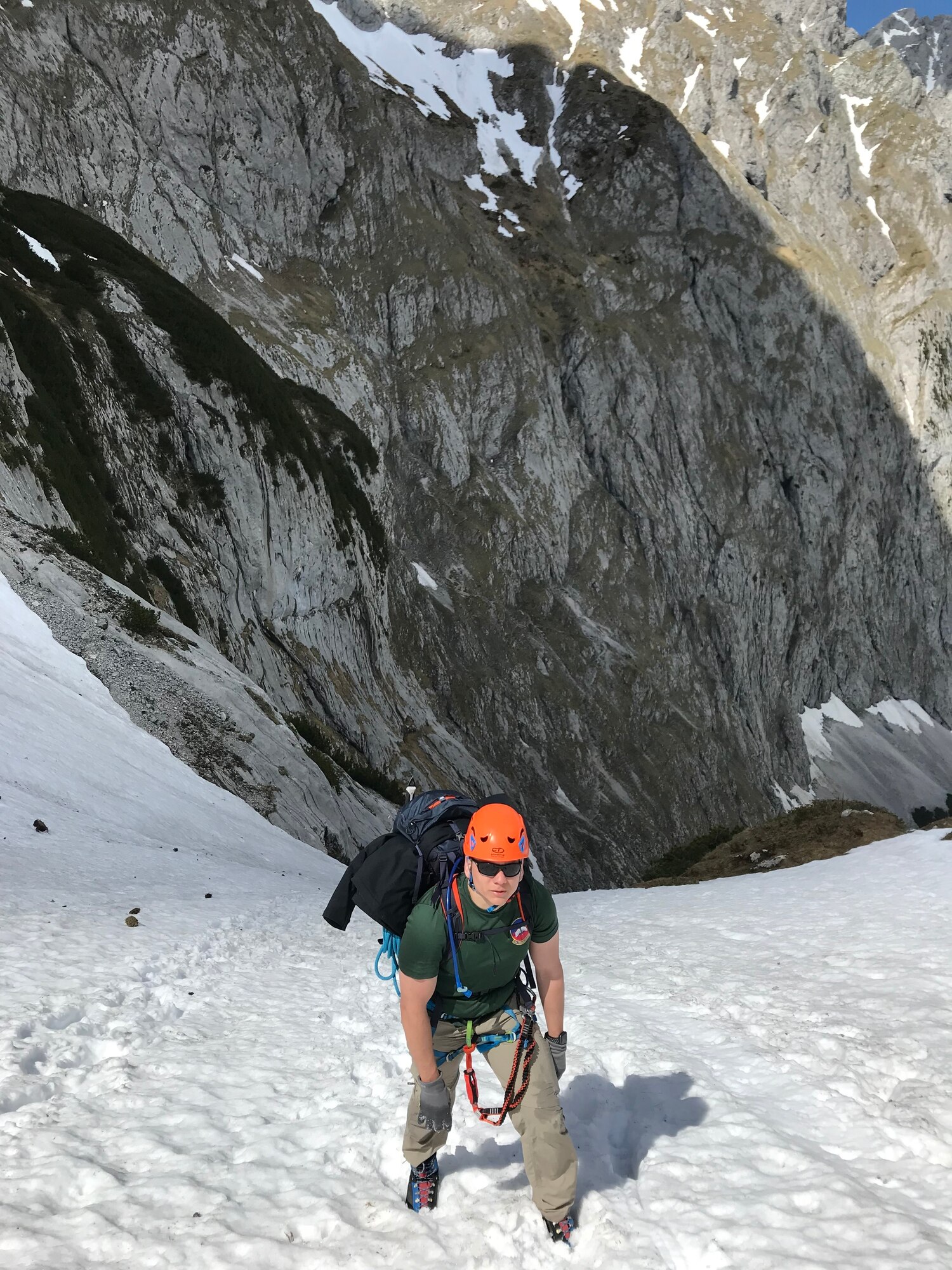 Senior Airman Ruben Madrid climbs up a mountain
