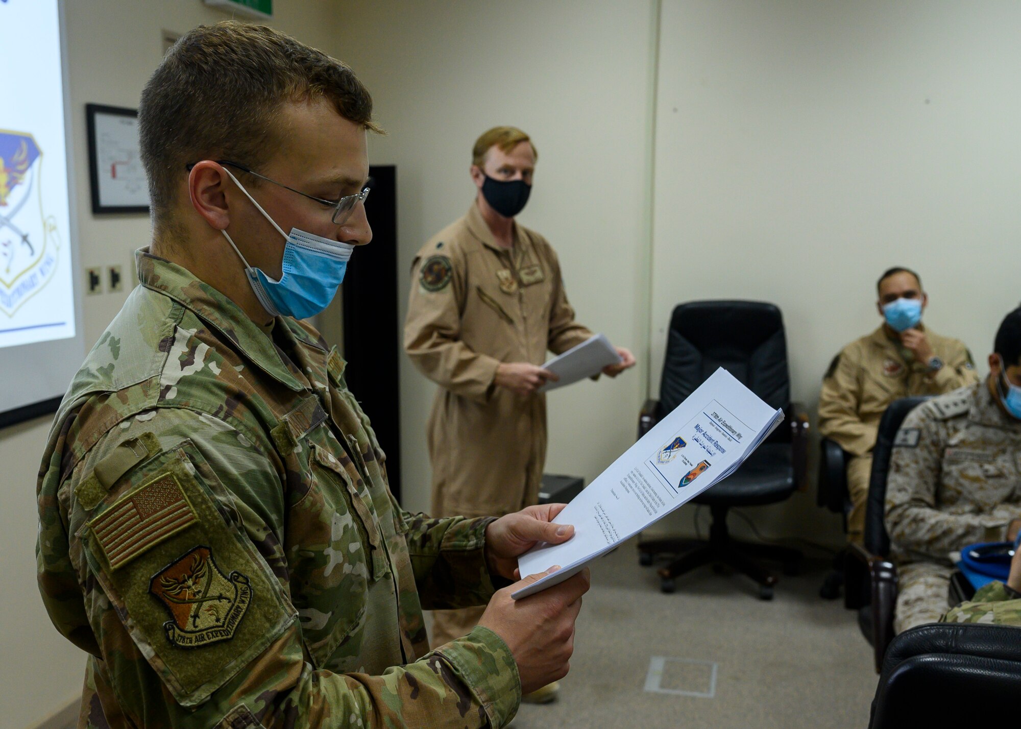 U.S. Air Force Staff Sgt. Noah Demaio, 378th Air Expeditionary Wing Arabic translator, and U.S. Air Force Lt. Col Timothy Tendall, 378th Air Expeditionary Wing Chief of Safety, explain the event agenda to participants of a Major Accident Response Exercise at Prince Sultan Air Base, Kingdom of Saudi Arabia, Oct. 6, 2021. The event was the first time both RSAF and USAF personnel at PSAB have participated in an integrated MARE, demonstrating the continued growth of the local partner nation relationship. (U.S. Air Force photo by Senior Airman Samuel Earick)