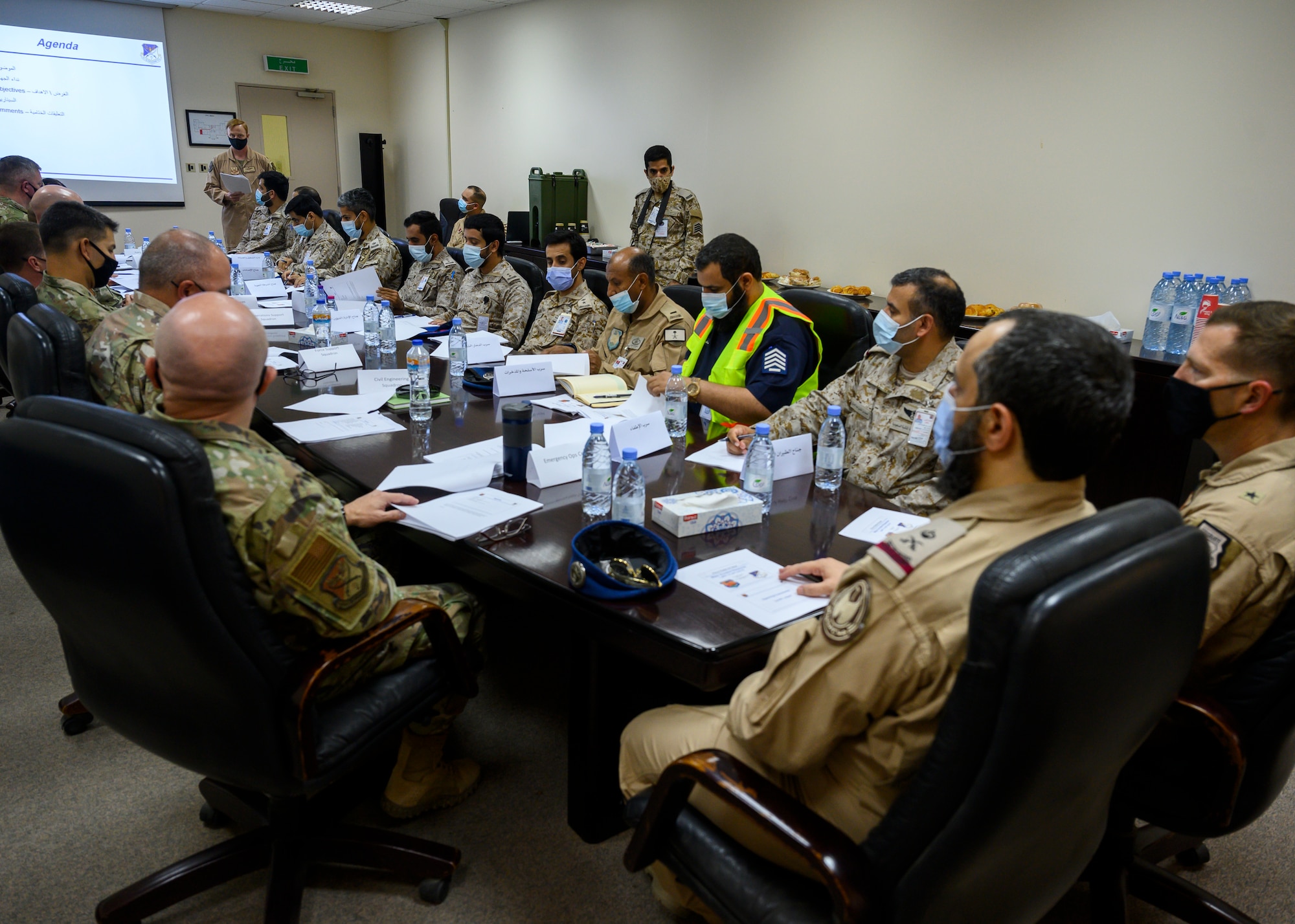 Royal Saudi Air Force personnel and 378th Air Expeditionary Wing members discuss emergency response actions during a Major Accident Response Exercise at Prince Sultan Air Base, Kingdom of Saudi Arabia, Oct. 6, 2021. The event was the first time both RSAF and USAF personnel at PSAB have participated in an integrated MARE, demonstrating the continued growth of the local partner nation relationship. (U.S. Air Force photo by Senior Airman Samuel Earick)