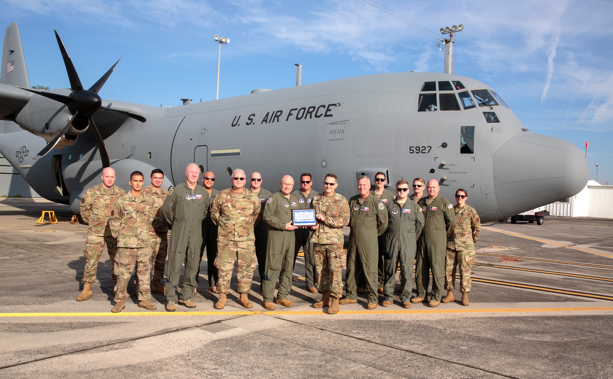 U.S. Air Force Col. Blair Morris (right), Lockheed Martin Marietta Defense Contract Management Agency commander,  relinquishes C-130J Super Hercules 5927 to Texas Air National Guard Col. Keith Williams (left), 136th Airlift Wing commander, Oct. 14, 2021, in Marietta, Georgia. The C-130J aircraft will introduce upgraded avionics, smaller aircrew requirements, more cargo space and increased longevity.  (Courtesy photo from Lockheed Martin, Thinh D. Nguyen)