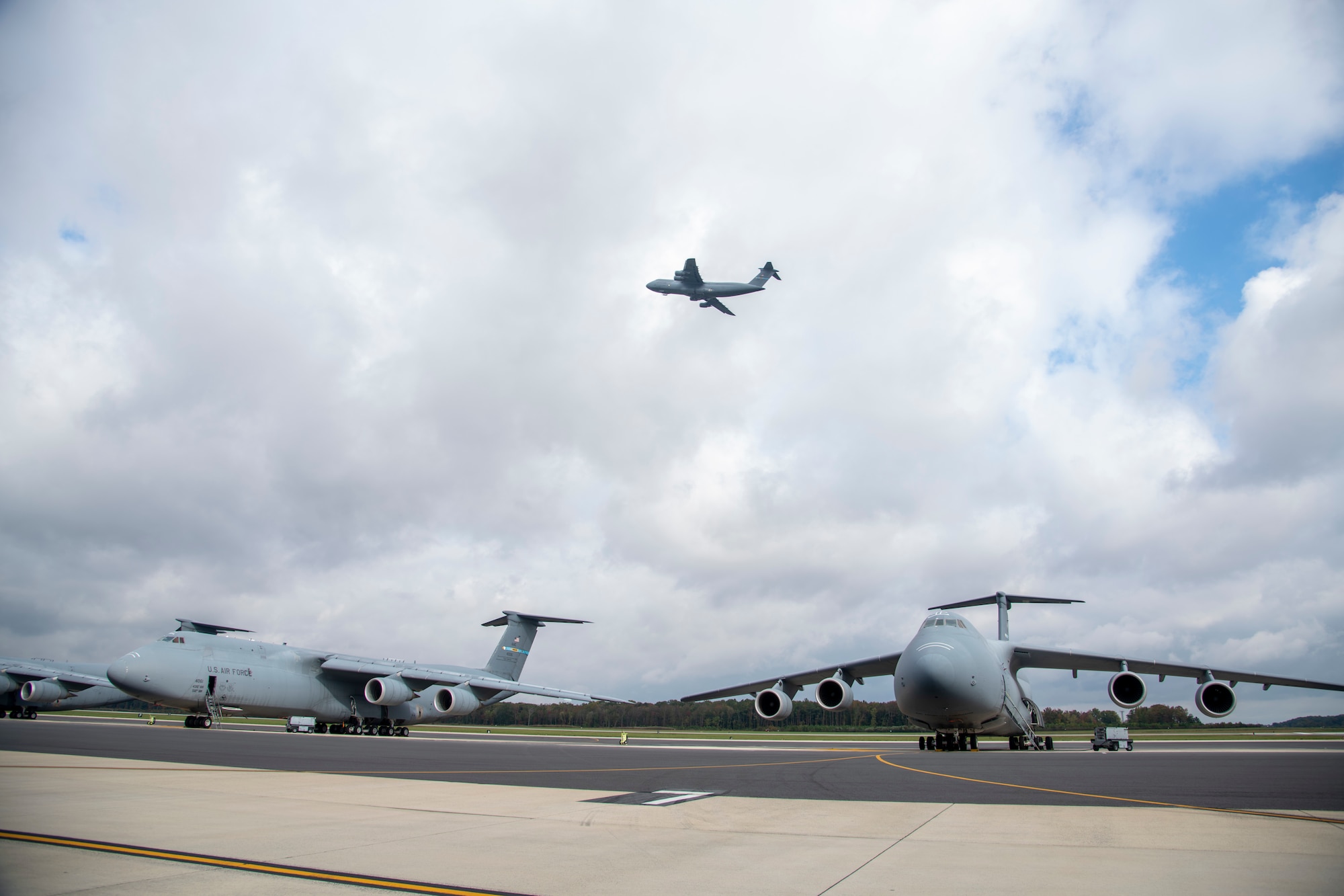 A C-5M Super Galaxy flies over Dover Air Force Base, Delaware, Oct. 26, 2021. The C-5M, with a cargo load of 281,001 pounds, can fly 2,150 nautical miles, offload, and fly to a second base 500 nautical miles away from the original destination without aerial refueling. (U.S. Air Force photo by Tech. Sgt. Nicole Leidholm)