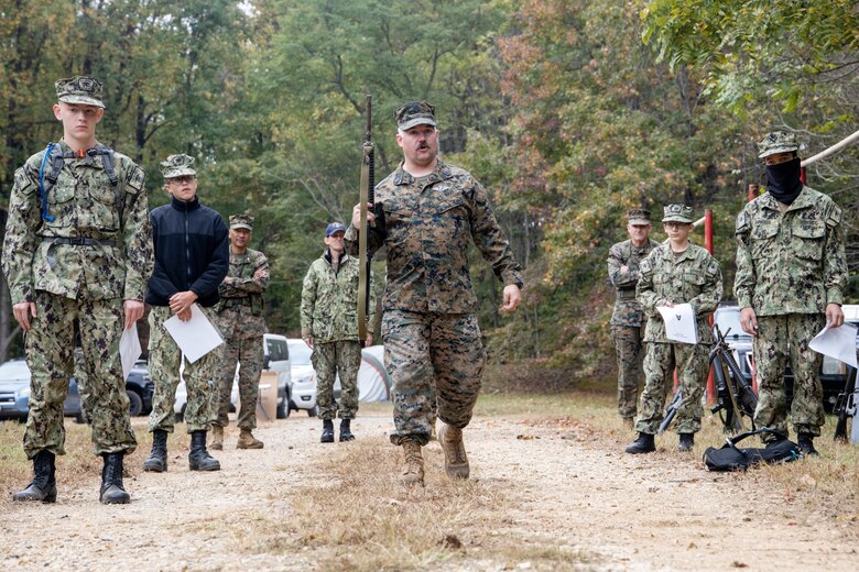 U.S. Navy Hospital Corpsman First Class Derrick A. Adkins, Marine Corps Recruiting Command Corpsman, teaches a class on weapons handling at Marine Corps Base Quantico, Oct. 23, Va. Marine Corps Recruiting Command volunteered to provide mentorship and training during the U.S. Naval Sea Cadet Corps' three-day field training exercise. (U.S Marine Corps photo by Lance Cpl. Gustavo Romero)