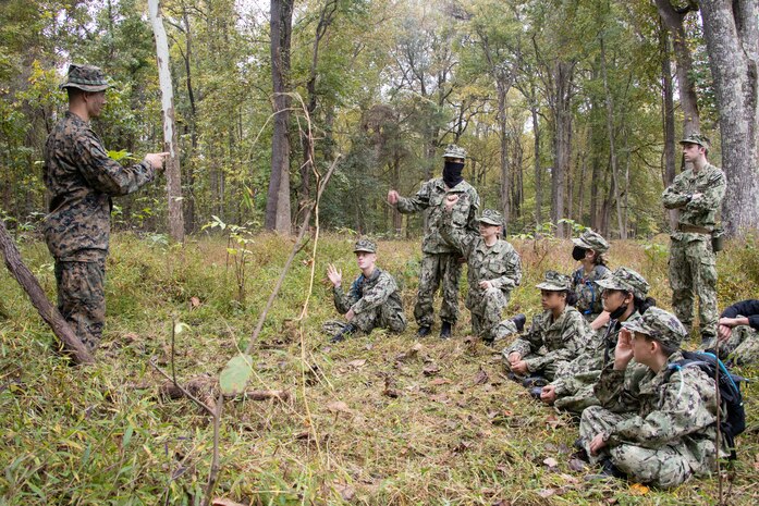 U.S. Marine Corps Lance Cpl. Jevon Gaytan, an administrative specialist, conduct a concealment class for the naval sea cadets at Marine Corps Base Quantico, Oct. 23, Va. Marine Corps Recruiting Command volunteered to provide mentorship and training during the U.S. Naval Sea Cadet Corps' three-day field training exercise. (U.S Marine Corps photo by Lance Cpl. Gustavo Romero)