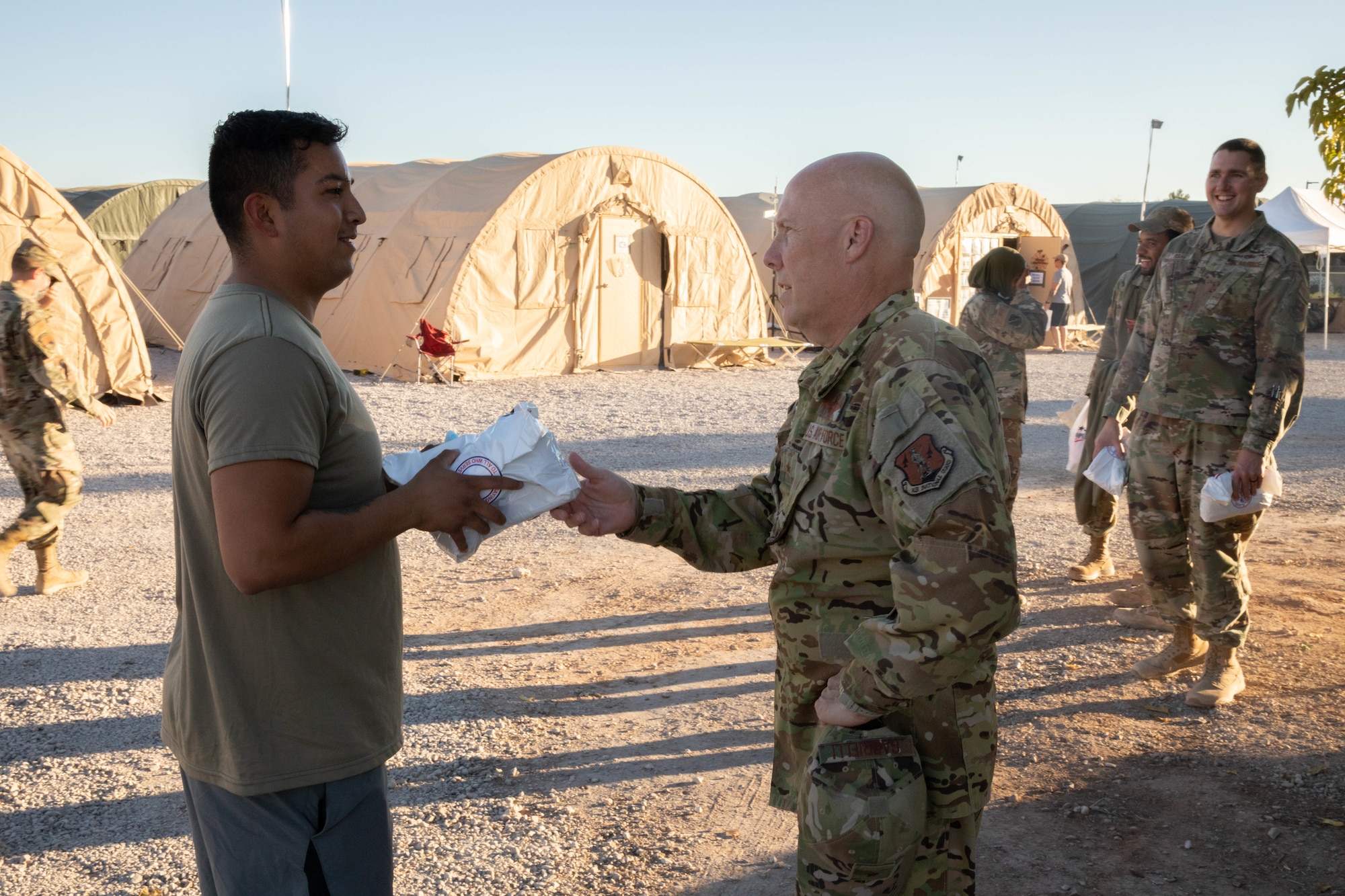 U.S. Air Force Brig. Gen. Daniel Gabrielli, Task Force Holloman commander, helps hand out care packages from Operation Gratitude for Airmen assigned to Task Force Holloman, a thanks for their hard work on Holloman Air Force Base, New Mexico, Oct. 19, 2021. The Department of Defense, through U.S. Northern Command, and in support of the Department of Homeland Security, is providing transportation, temporary housing, medical screening, and general support for at least 50,000 Afghan evacuees at suitable facilities, in permanent or temporary structures, as quickly as possible. This initiative provides Afghan personnel essential support at secure locations outside Afghanistan. (U.S. Army Photo By Pfc. Anthony Ford)