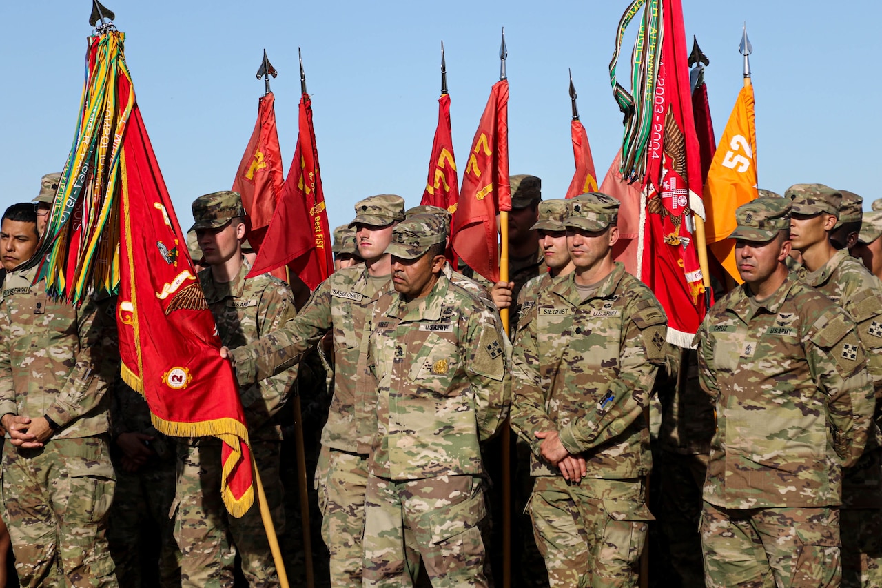 Service members stand in formation.