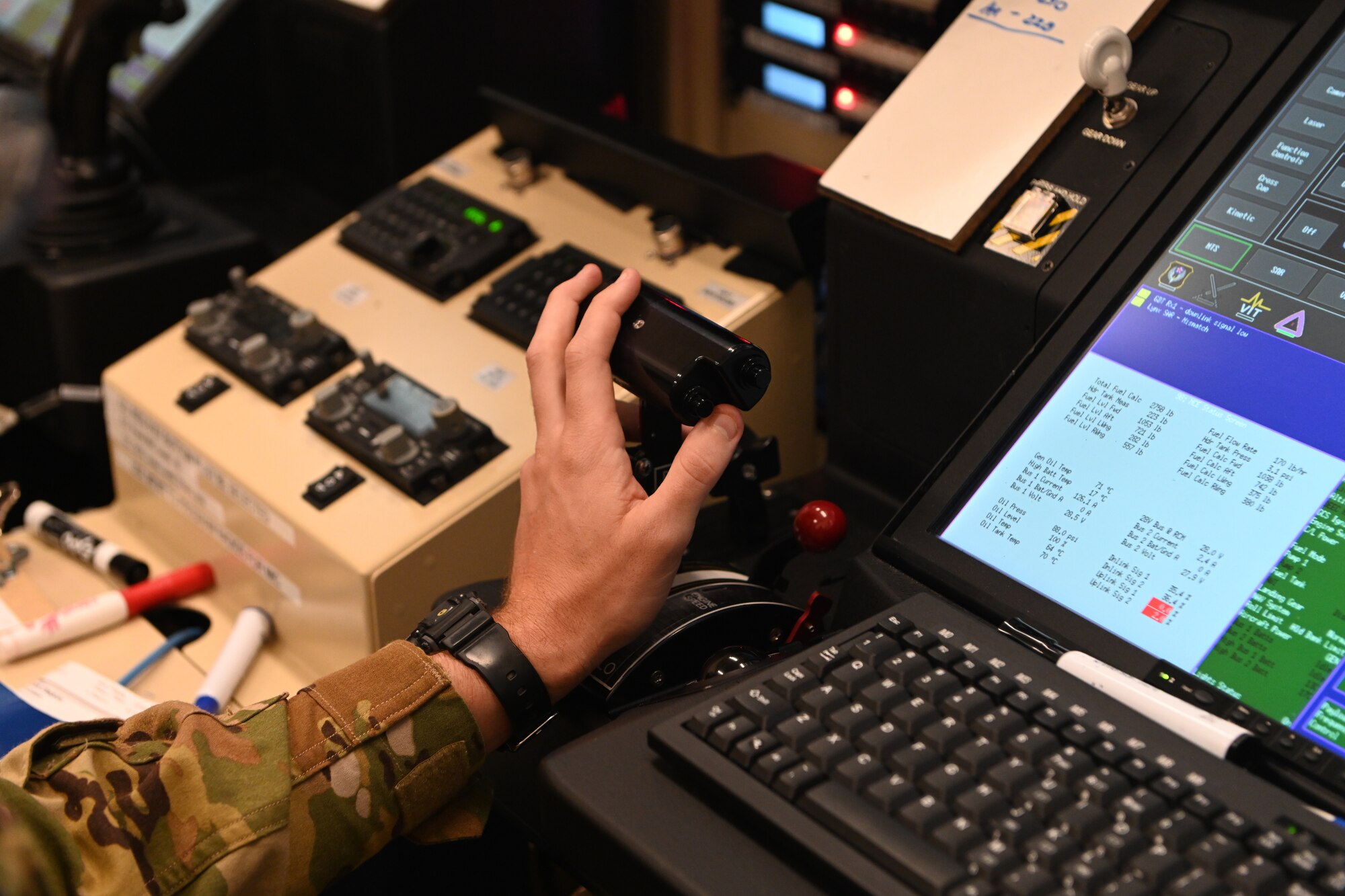 A MQ-9 Reaper sensor operator student, assigned to the 491st Attack Squadron, adjusts flight controls during an MQ-9 flight simulation training, July 14, 2021, on Hancock Field Air National Guard Base, New York. During these simulations, both the pilot and the sensor operator must learn to work together and successfully accomplish their responsibilities during all flight missions. (U.S. Air Force photo by Staff Sgt. Christopher Sparks)