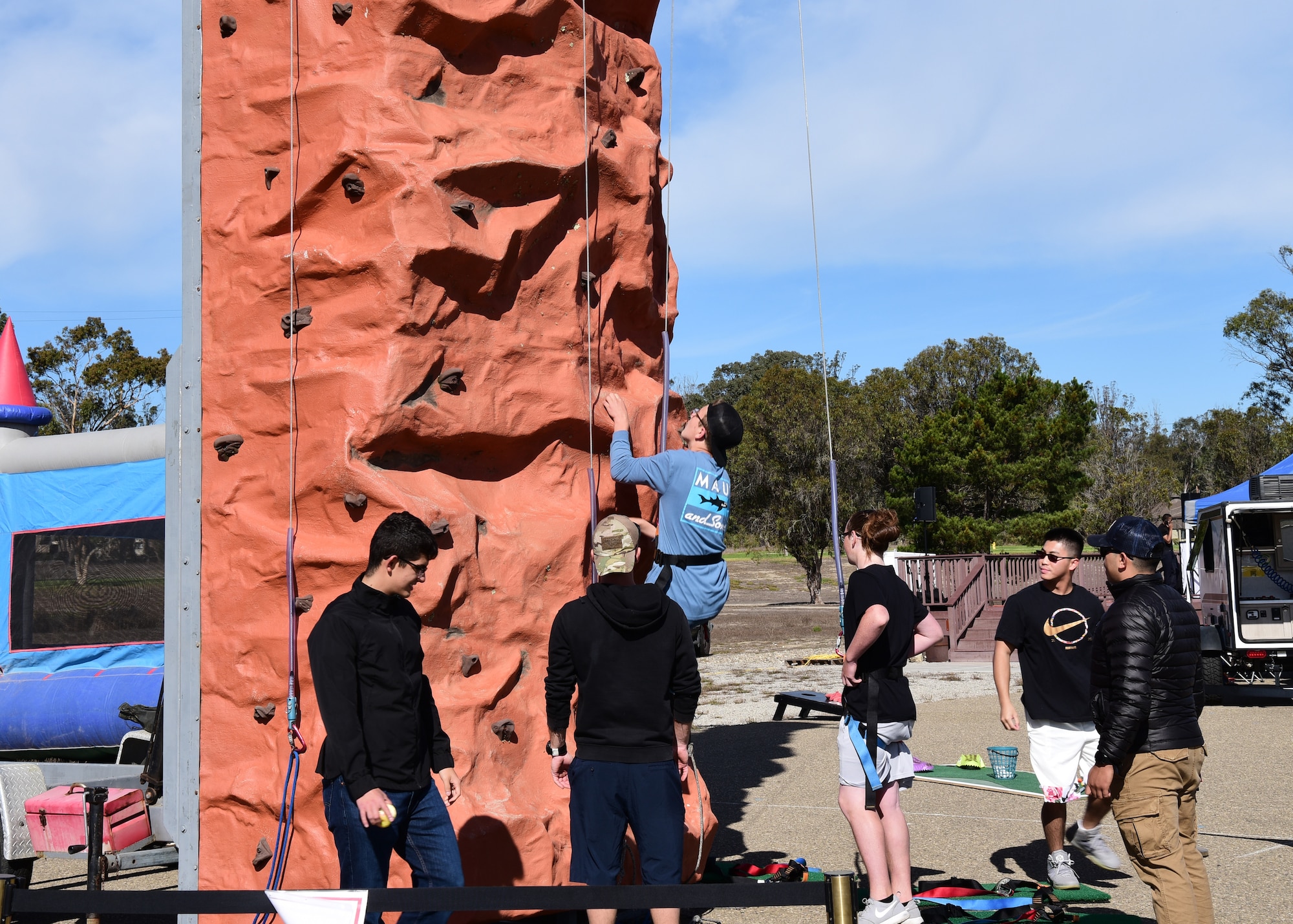Base personnel rock climb during Vandenberg’s Ninth Annual Exotic Car Show Oct. 23, 2021, at Vandenberg Space Force Base, Calif. The 30th Force Support Squadron coordinates with different business to provide family- friendly activities. (U.S. Space Force photo by Airman First Class Tiarra Sibley)