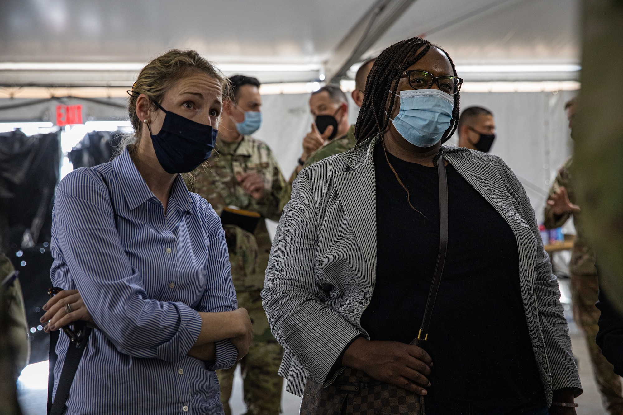 Ms. Heather King, Deputy Assistant Secretary of Defense for Homeland Integration and Defense Support of Civil Authorities, and Ms. Barbara Buteau-Pierre, the Office of the Under Secretary of Defense, Comptroller, is briefed by U.S. Air Force Lt. Col. Taylor “Latch” Francis, Task Force Holloman A3 director, on how Aman Omid Village operates within Holloman Air Force Base, New Mexico, Oct. 17, 2021. The Department of Defense, through U.S. Northern Command, and in support of the Department of Homeland Security, is providing transportation, temporary housing, medical screening, and general support for at least 50,000 Afghan evacuees at suitable facilities, in permanent or temporary structures, as quickly as possible. This initiative provides Afghan personnel essential support at secure locations outside Afghanistan. (U.S. Army photo by Pfc. Anthony Sanchez)