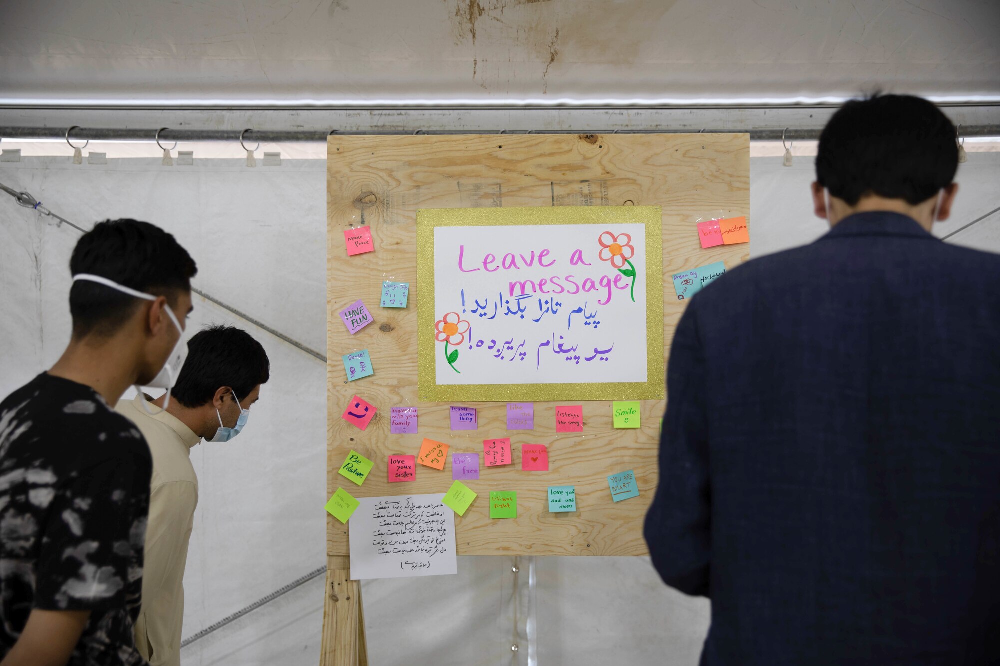 Afghan evacuees practice reading and writing in English during the opening of a new education center at Aman Omid Village on Holloman Air Force Base, New Mexico, Oct. 19, 2021. The Department of Defense, through U.S. Northern Command, and in support of the Department of Homeland Security, is providing transportation, temporary housing, medical screening, and general support for at least 50,000 Afghan evacuees at suitable facilities, in permanent or temporary structures, as quickly as possible. This initiative provides Afghan personnel essential support at secure locations outside Afghanistan. (U.S. Army Photo By Pfc. Anthony Ford)