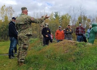 Lt. Col. David Fabricious, range director of plans and operations, training site command, Garrison Support Command describes individual weapon qualification standards on a pistol range at Camp Ethan Allen Training Site, Oct. 22, 2021. Military retirees and neighbors of the range, among others, participated in a public tour of CEATS where they received an overview of range operations and visited military barracks; construction of a new Army Mountain Warfare School; weapon ranges; and the biathlon program. (U.S. Army photo by Maj. J. Scott Detweiler)