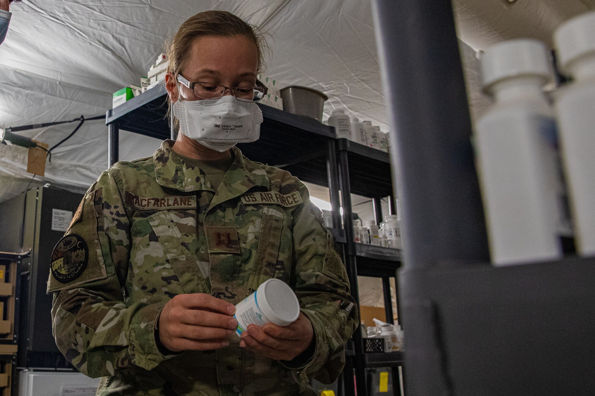 U.S. Air Force Capt. Raquel MacFarlane, Task Force Holloman head pharmacist, checks medication prescribed to Afghan evacuees on Holloman Air Force Base, New Mexico, Oct. 14, 2021. The Department of Defense, through U.S. Northern Command, and in support of the Department of Homeland Security, is providing transportation, temporary housing, medical screening, and general support for at least 50,000 Afghan evacuees at suitable facilities, in permanent or temporary structures, as quickly as possible. This initiative provides Afghan personnel essential support at secure locations outside Afghanistan. (U.S. Army photo by Pfc. Anthony Sanchez)