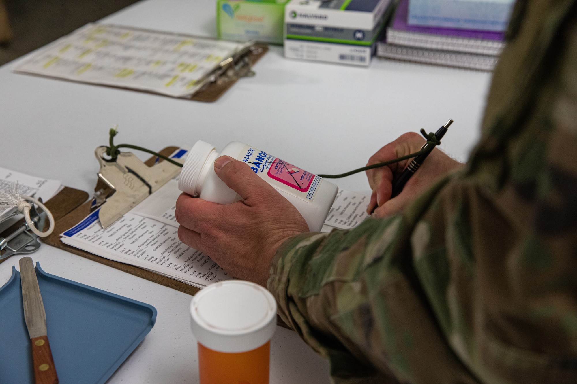 U.S. Air Force Staff Sgt. Dustin Stevens, Task Force Holloman pharmacy lead, prescribes medication to Afghan evacuees on Holloman Air Force Base, New Mexico, Oct. 14, 2021. The Department of Defense, through U.S. Northern Command, and in support of the Department of Homeland Security, is providing transportation, temporary housing, medical screening, and general support for at least 50,000 Afghan evacuees at suitable facilities, in permanent or temporary structures, as quickly as possible. This initiative provides Afghan personnel essential support at secure locations outside Afghanistan. (U.S. Army photo by Pfc. Anthony Sanchez)