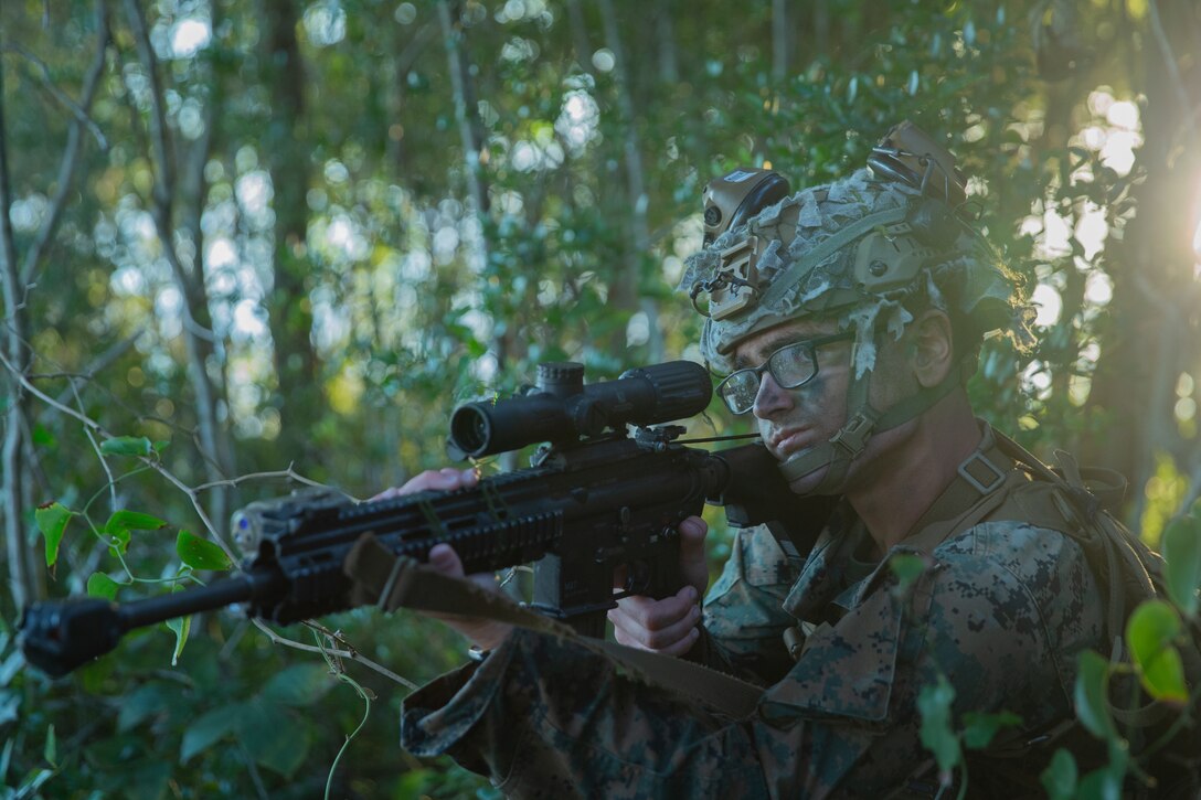 U.S. Marine Corps Lance Cpl. Hunter G. Roberts, a rifleman with 1st Battalion, 2d Marine Regiment, 2d Marine Division, posts security on Bogue Airfield, N.C., Oct. 18, 2021. The Marines participated in amphibious and company-level infiltration across multiple locations as part of Strip Map, a specialized evaluation used to determine the efficacy of experimental ground formations. (U.S. Marine Corps photo by Lance Cpl. Michael Virtue)