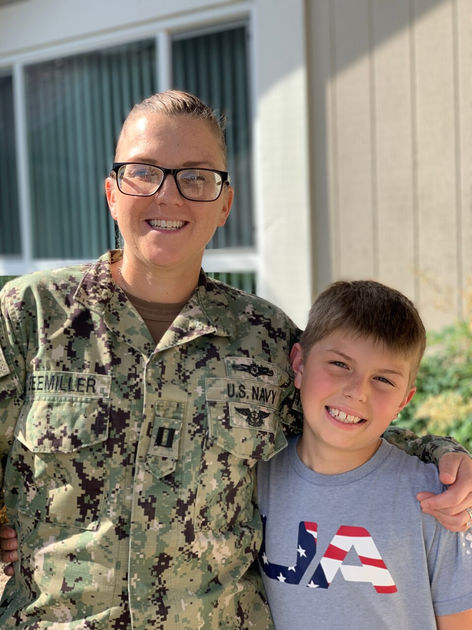 Breast cancer survivor, Lt. Sarah Beemiller and son pose while in uniform.